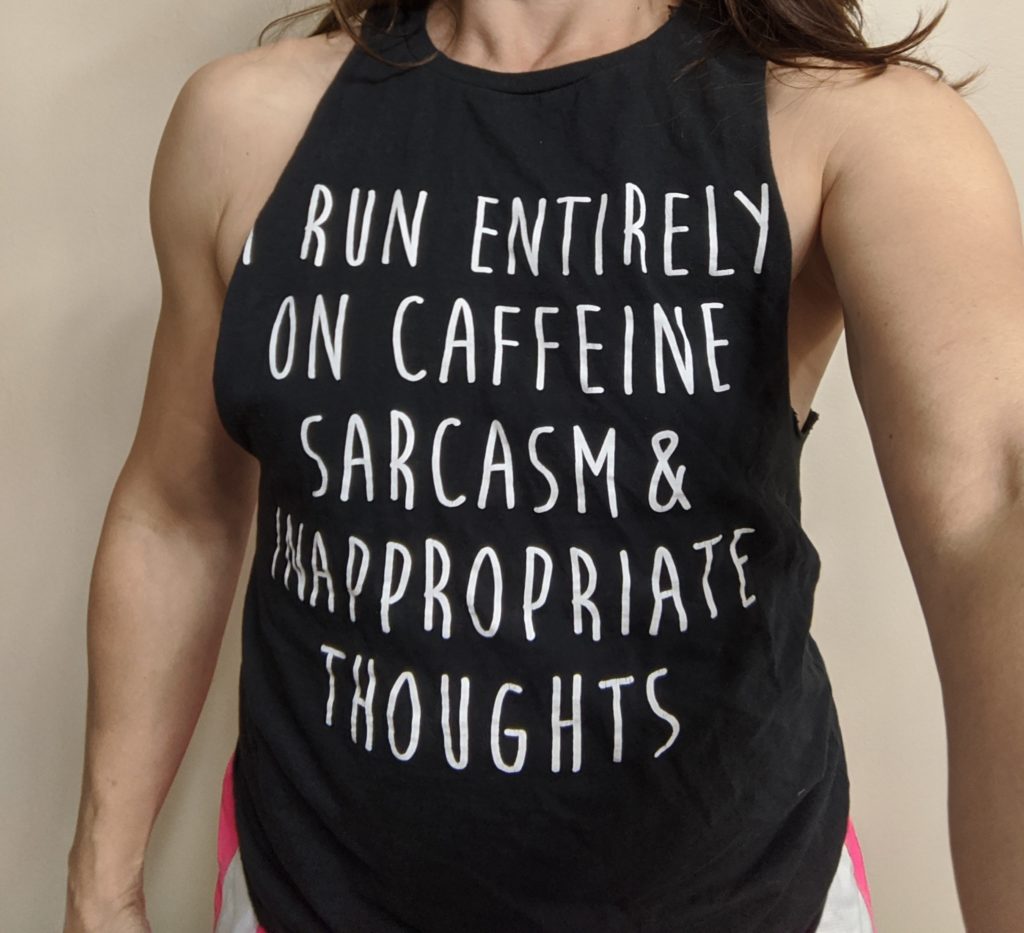 Woman wearing t-shirt that says, "I run entirely on caffeine sarcasm and inappropriate thoughts"